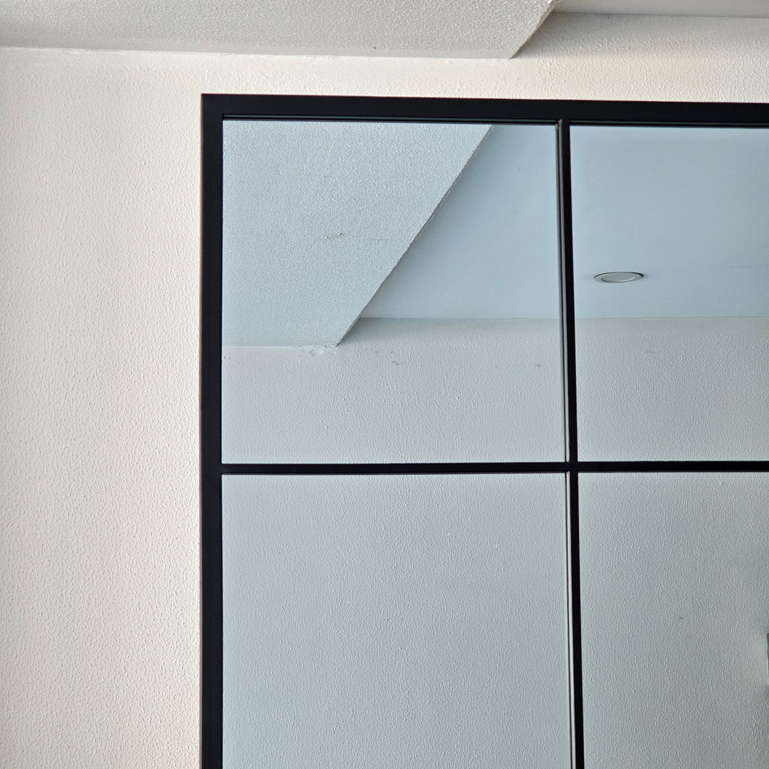 Large black window mirror with a bold industrial design