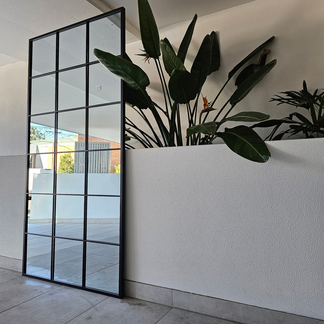 Large black window mirror with a bold industrial design