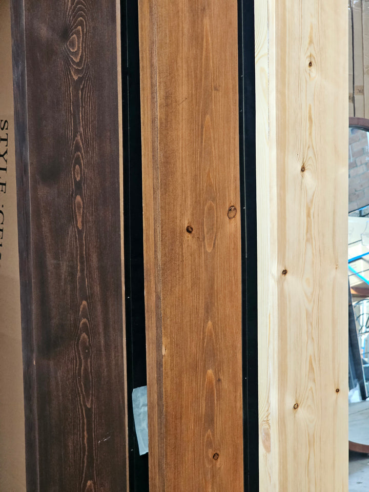 Oversized rustic wood wall mirror leaning on wall