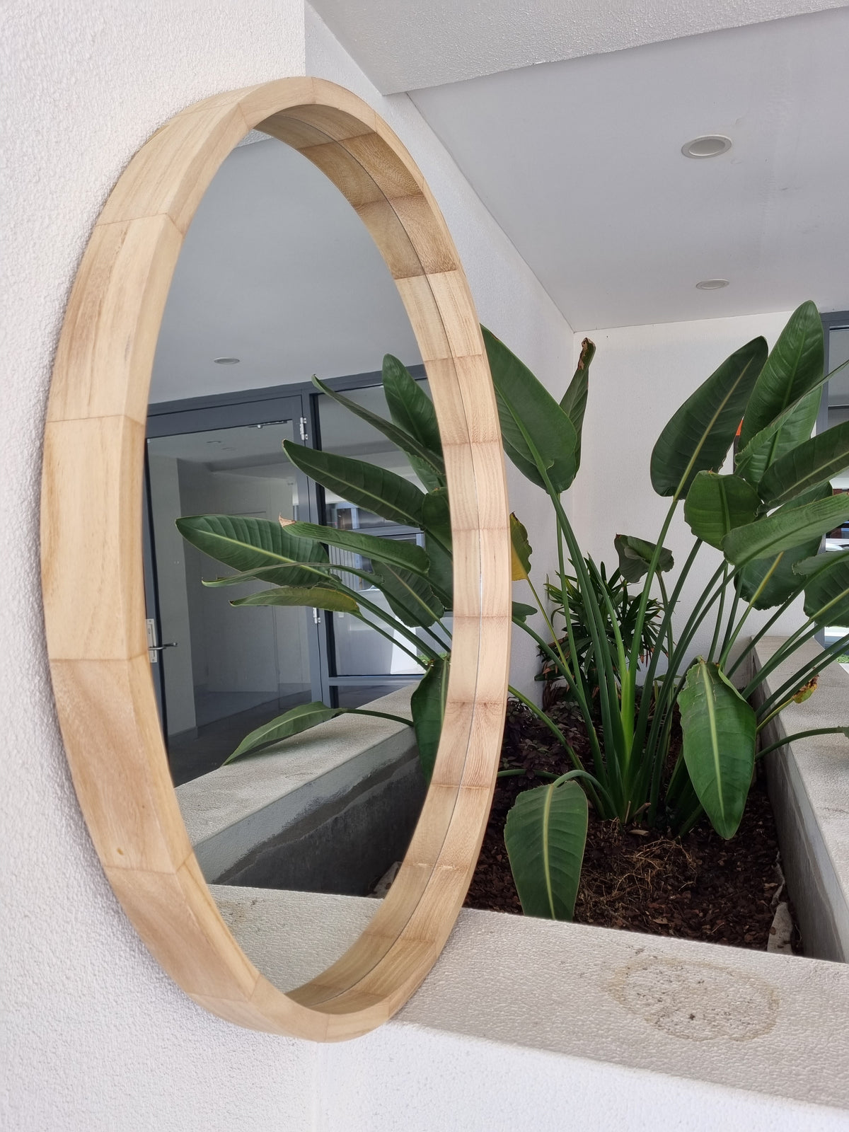 Round wall mirror with a thin metal frame, available 80 to 110cm