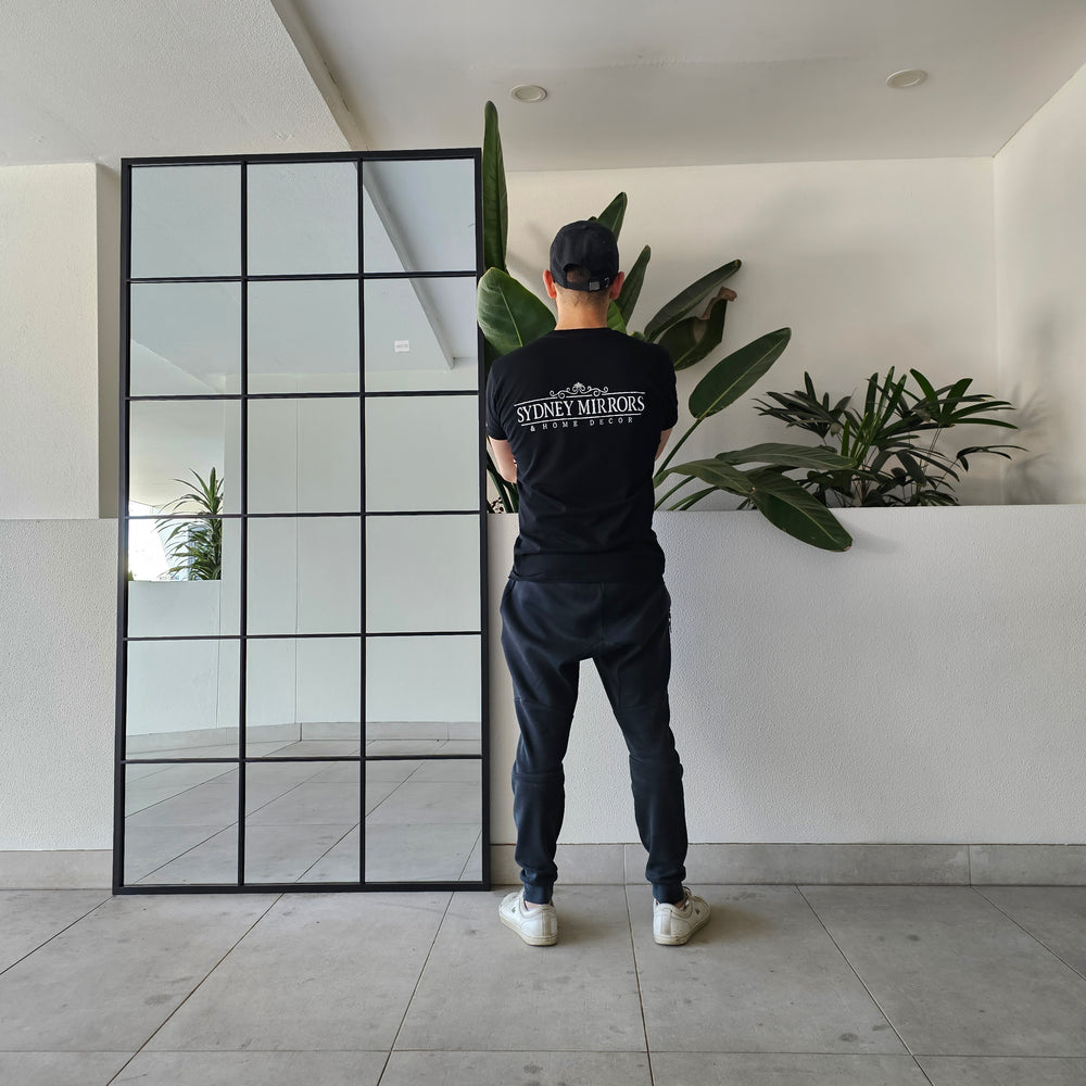 Large black window mirror with a bold industrial design