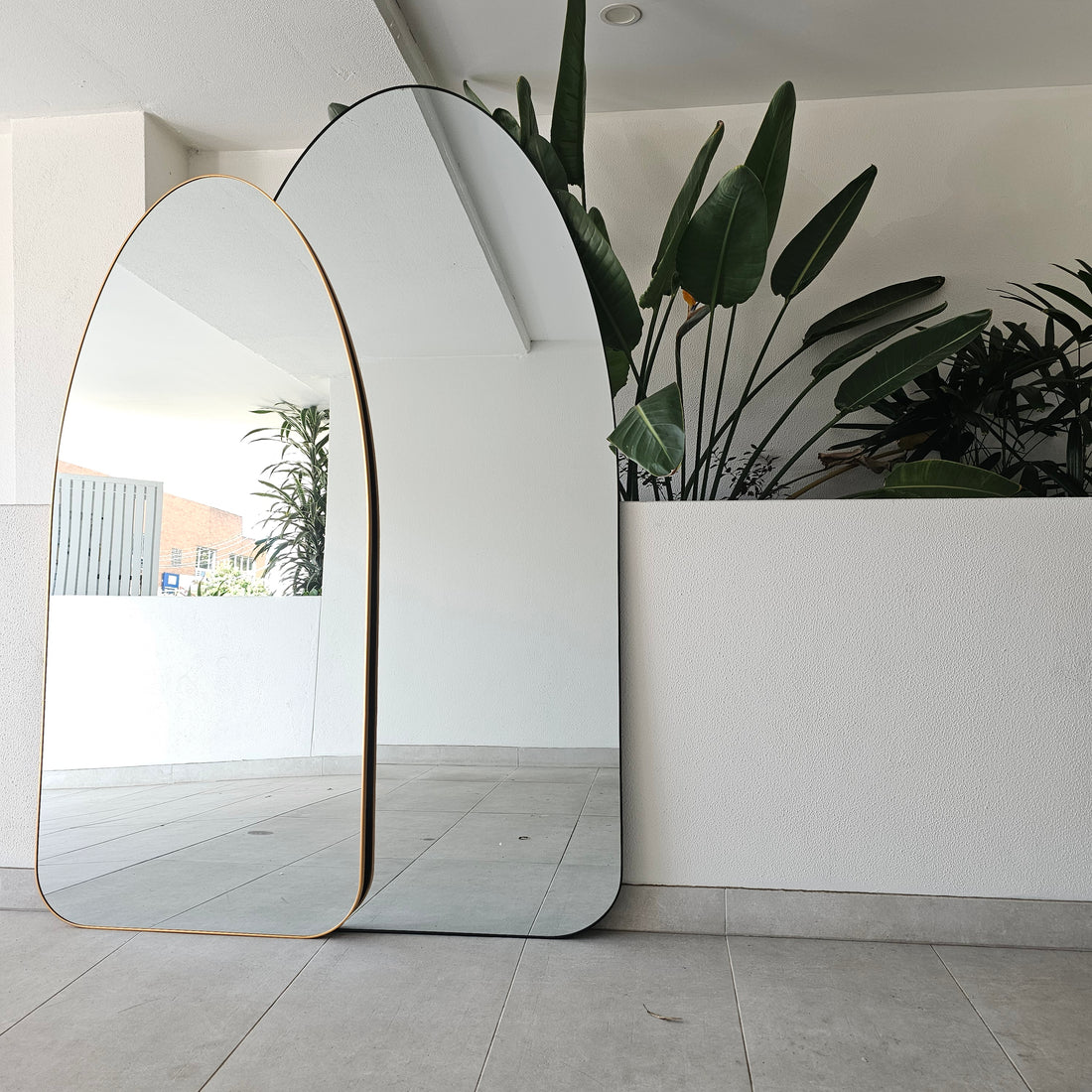 Odyssey black irregular arch full-length mirror with a metal frame