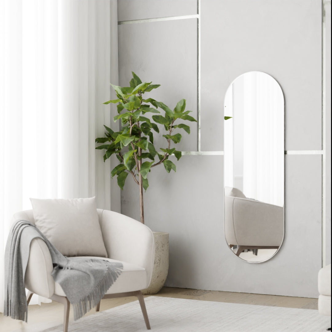 Pill-shaped frameless wall mirror in minimalist living room