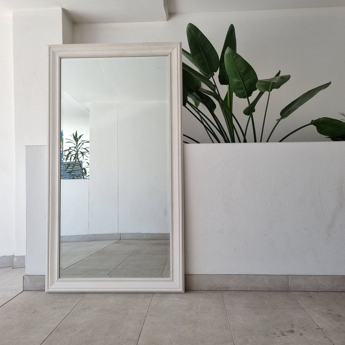 White embossed full-length mirror with a moulded frame
