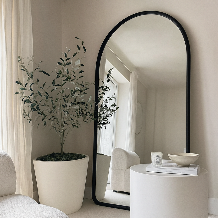 Aura full-length mirror in warm dark wood leaning on wall
