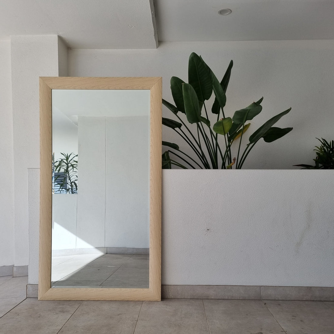 Light wood full-length mirror with a natural timber frame