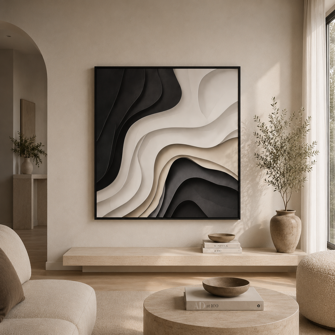 Strata sculptural wall art, black cream and taupe layered canvas print in a black frame, 210x120cm, on a warm white living room wall