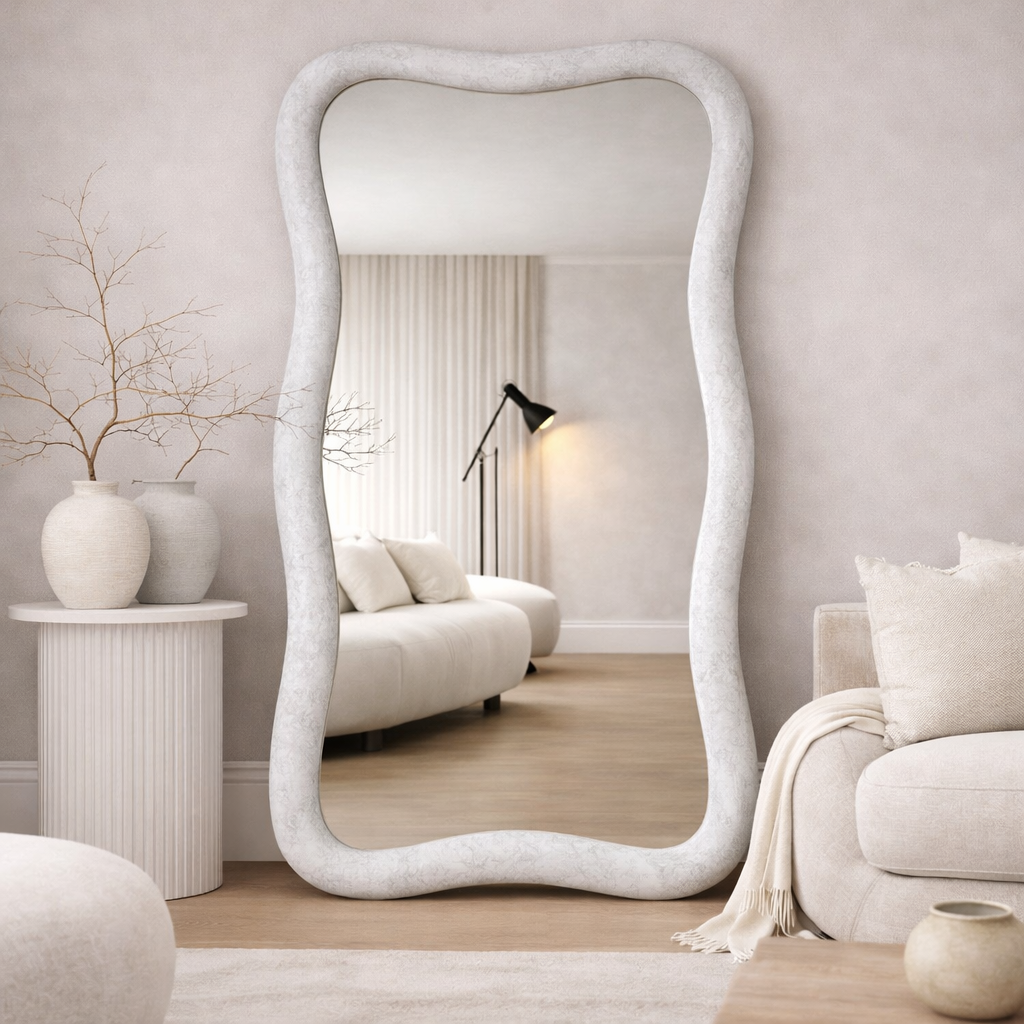 Modern living room with a large decorative mirror and neutral decor.