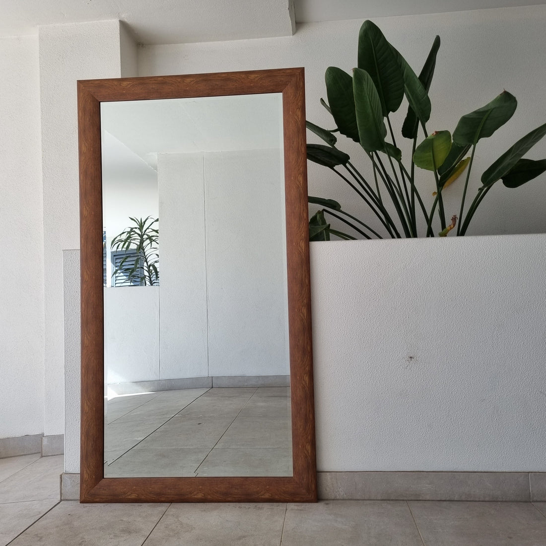 Brown rectangular full-length mirror with a timber frame