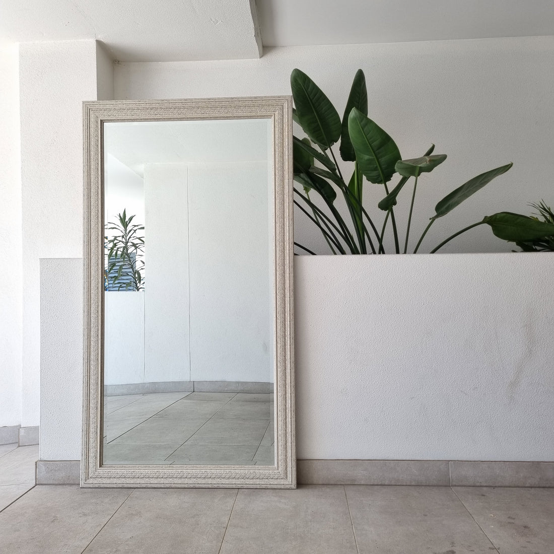 Distressed full-length mirror with a shabby-chic timber frame