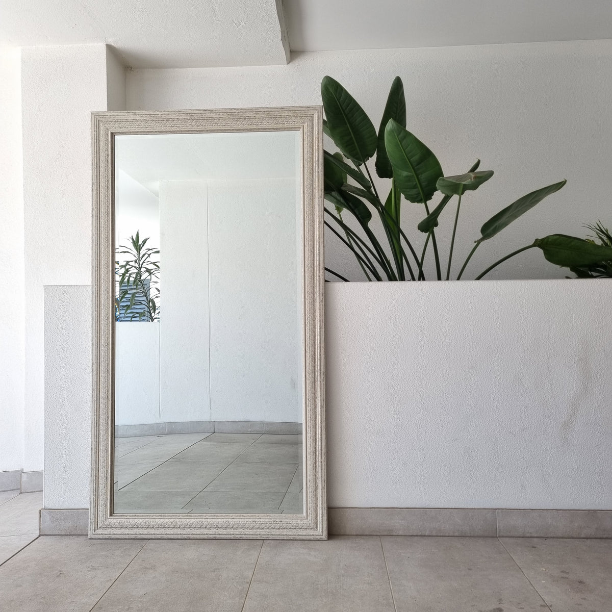 Distressed full-length mirror with a shabby-chic timber frame