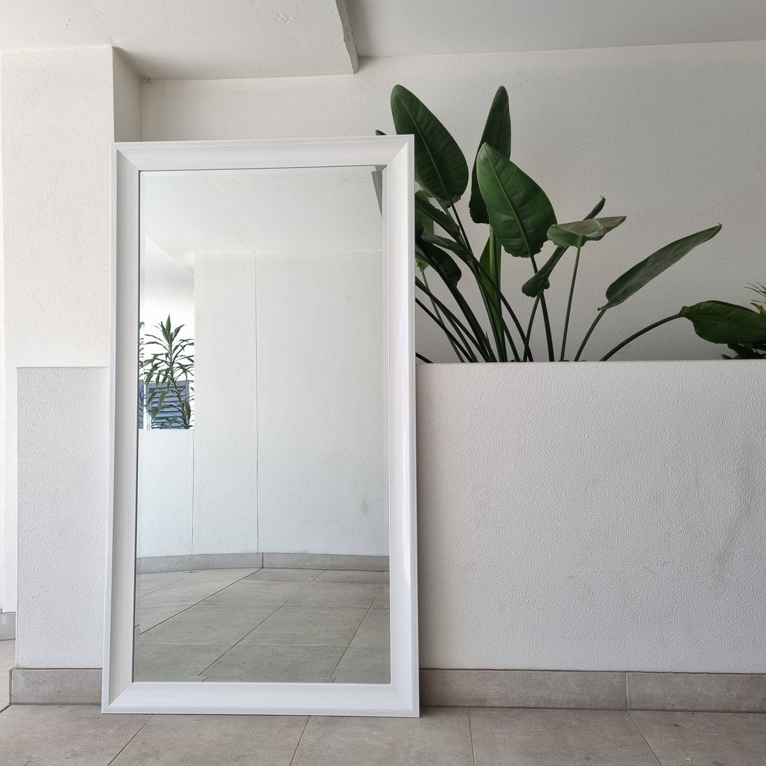 White full-length mirror with a thick moulded frame