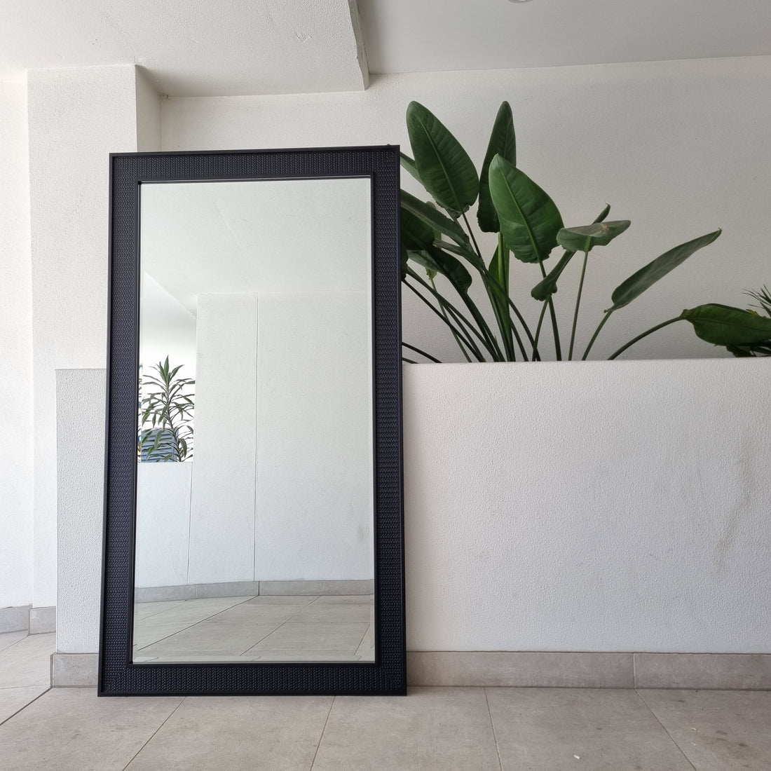 Black C full-length mirror with a curved black frame